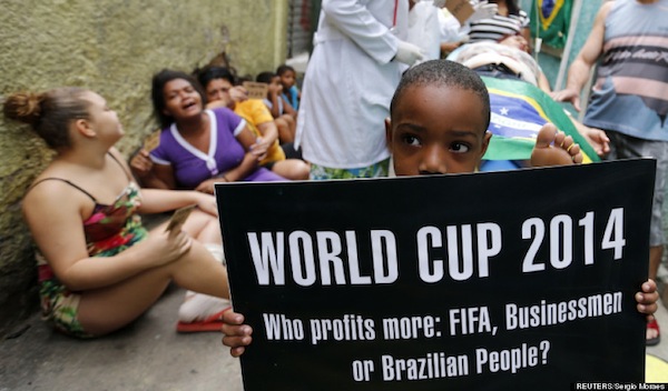 Residents simulate bad service at a public hospital during a protest against the 2014 World Cup, organized by non-governmental organization (NGO) Rio de Paz (Rio of Peace) at the Jacarezinho slum in Rio de Janeiro